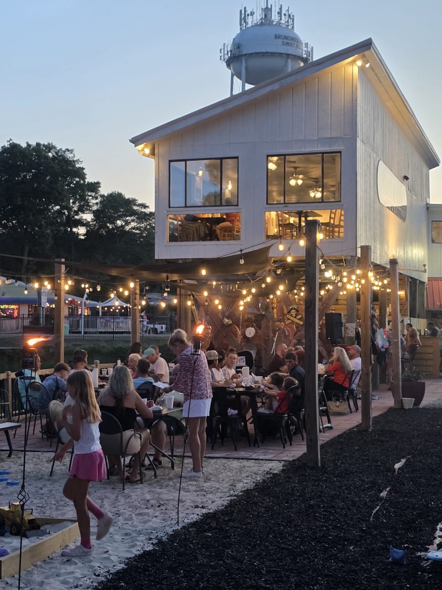 Patio seating under string lights at Rustic Reel